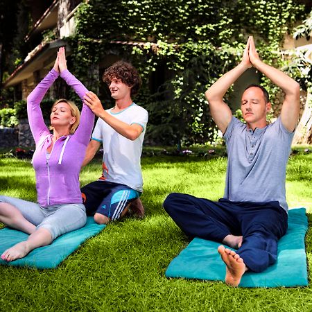 Marti Myra Hotel Tekirova Exterior photo A yoga teacher assists students with their practice.