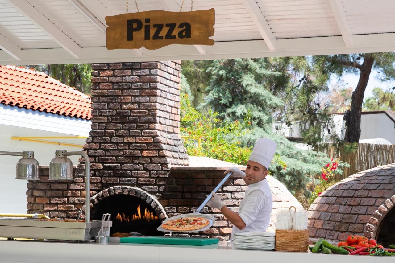 Marti Myra Hotel Tekirova Exterior photo Pizza being prepared in a wood-fired oven